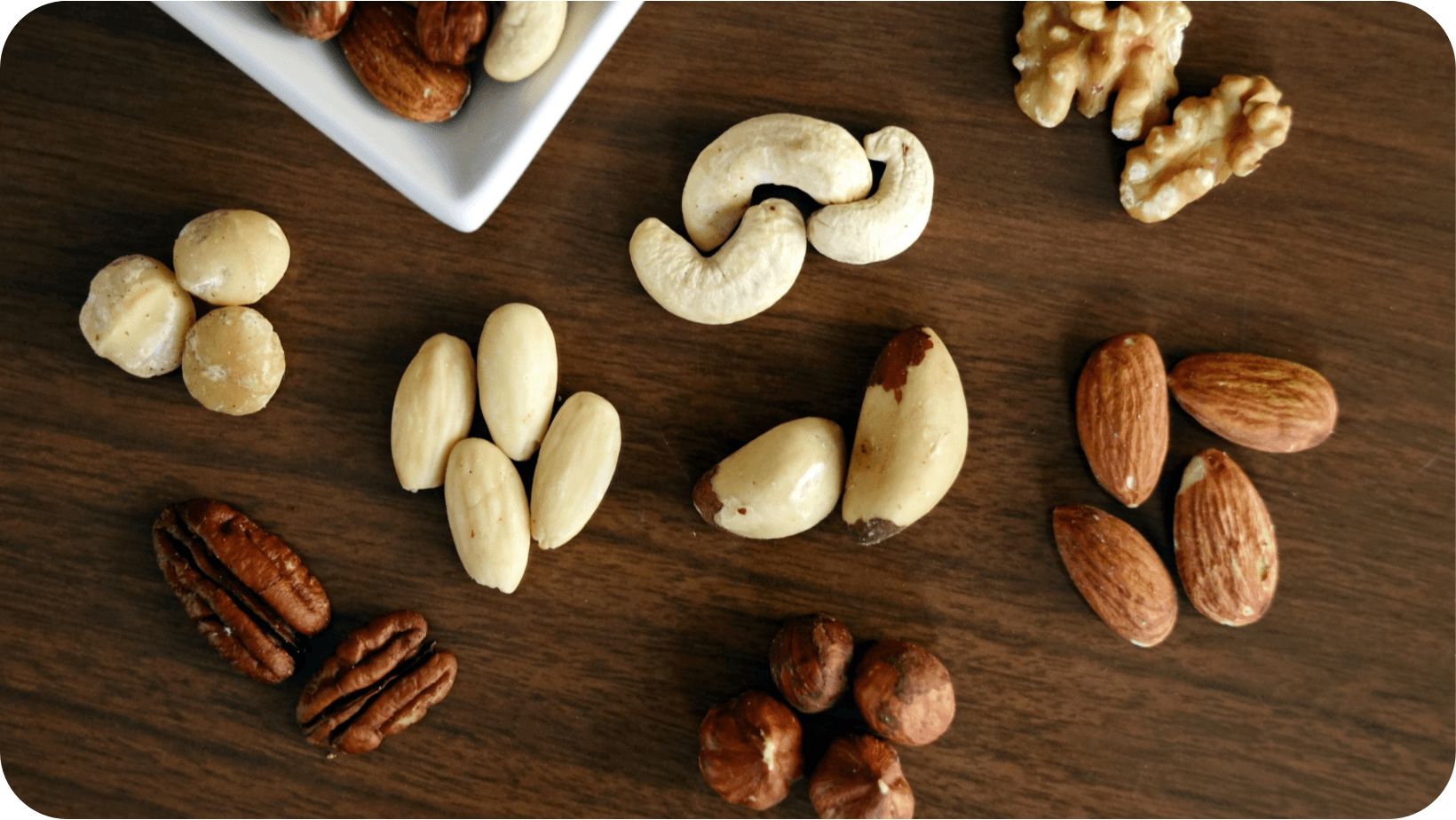 Variety of types of nuts on a wooden table