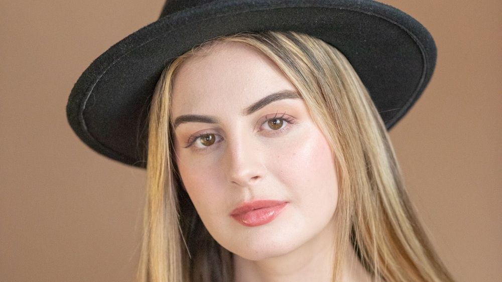 Jamie Logan wearing a black hat