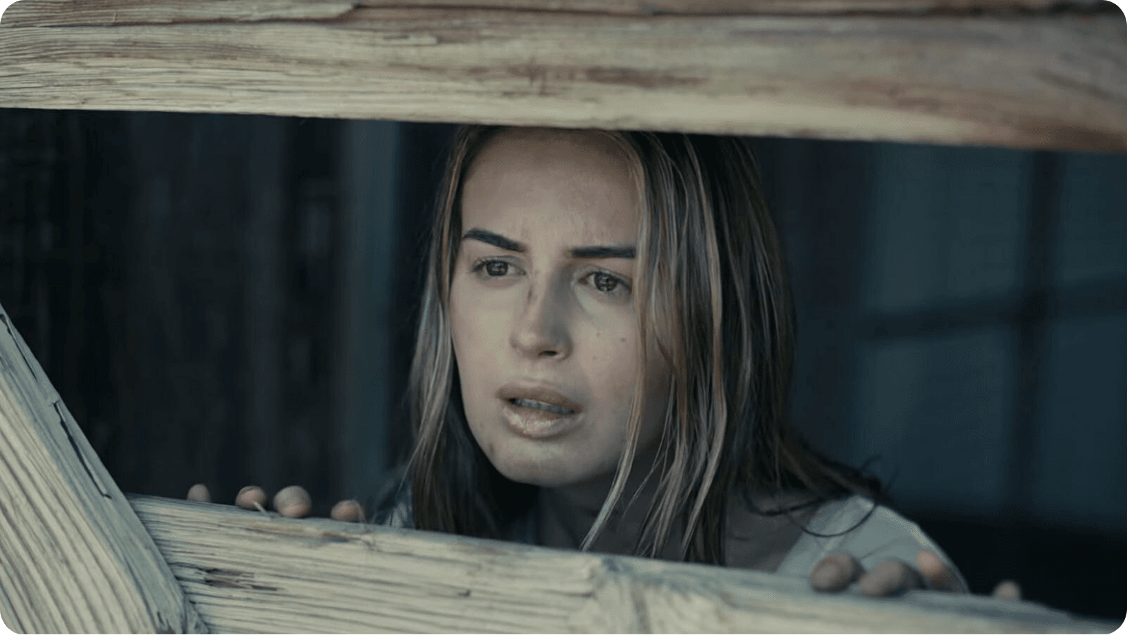 Jamie Logan looking upset behind a fence while playing the lead role in short film, The Next Girl