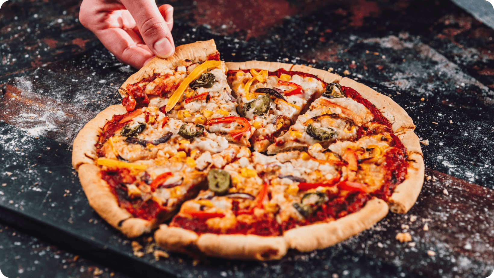 One Planet Pizza’s ‘Tex Mex’ vegan pizza, cut into slices on a counter