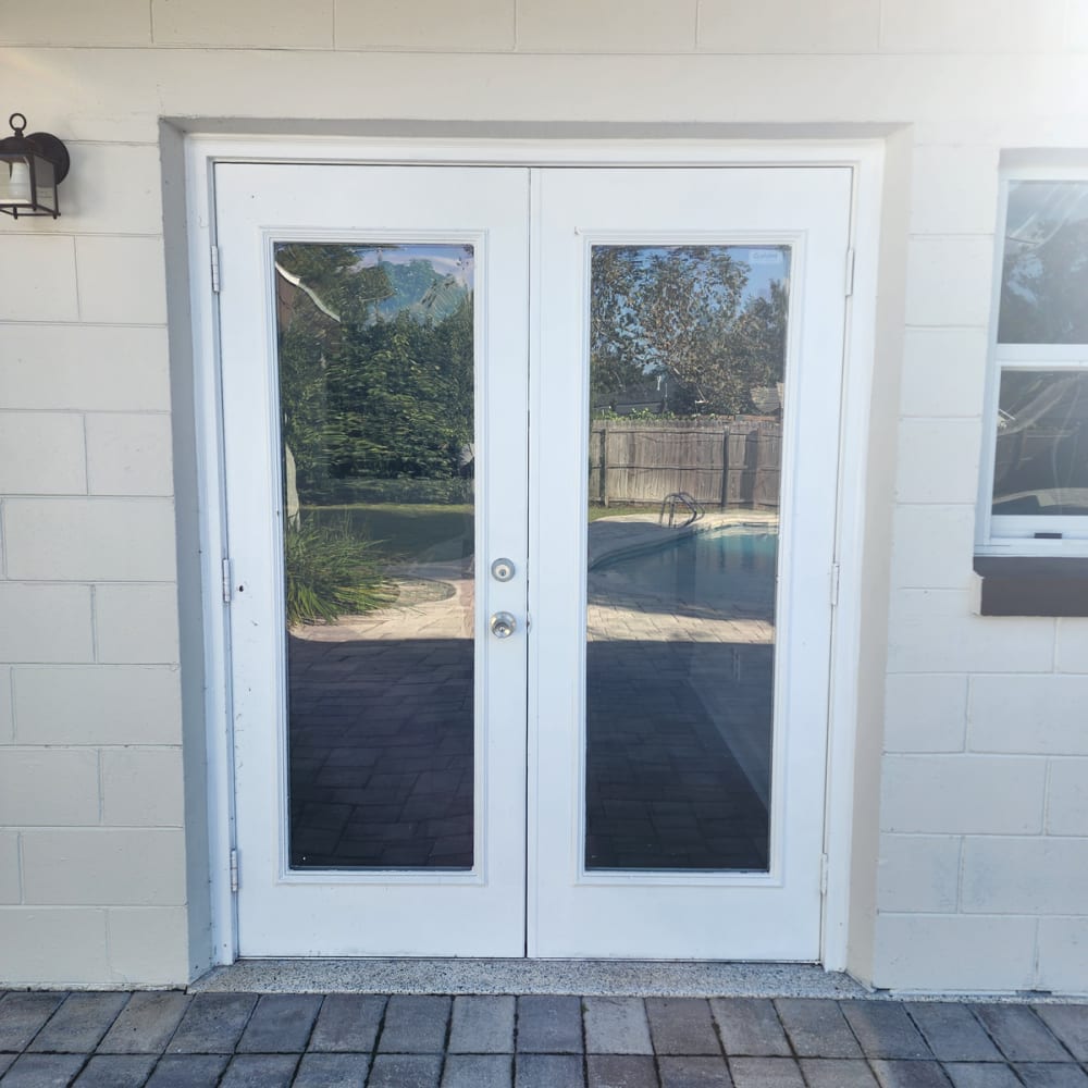 Repaired residential patio door and commercial storefront glass after break-in damage in Central Florida