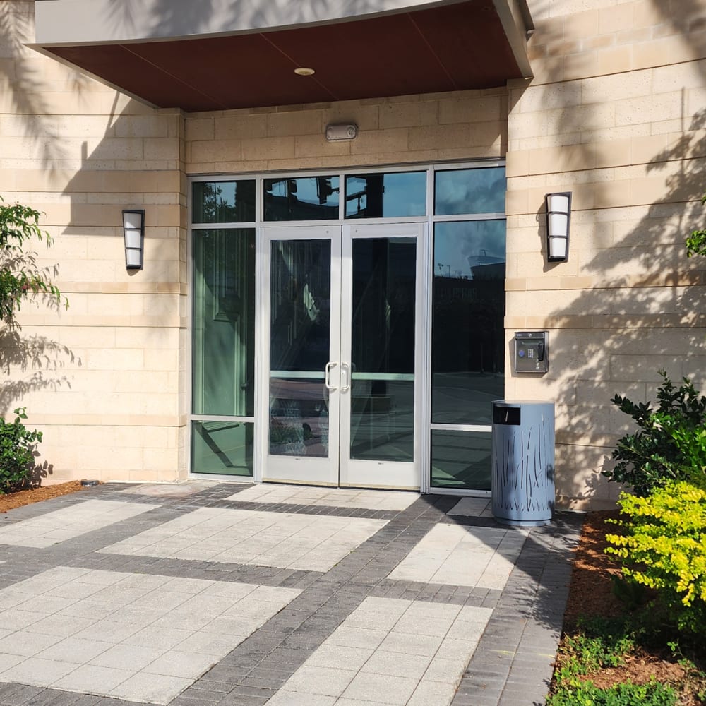 Aligned commercial glass door bottom rail with clean weatherstripping after maintenance in a managed property