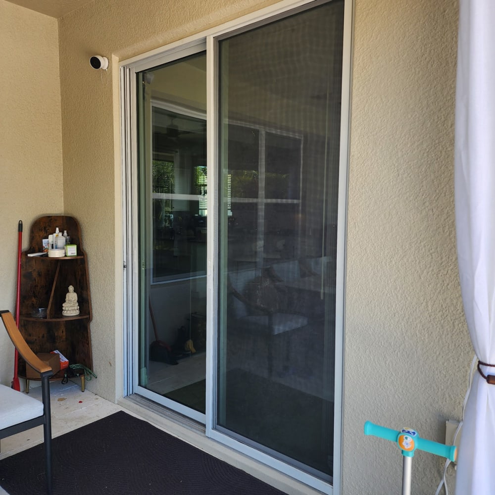 Large living room windows and sliding door in an Orlando home showing key locations for impact glass upgrades