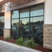highly rated commercial storefront glass service shown with five star review graphics