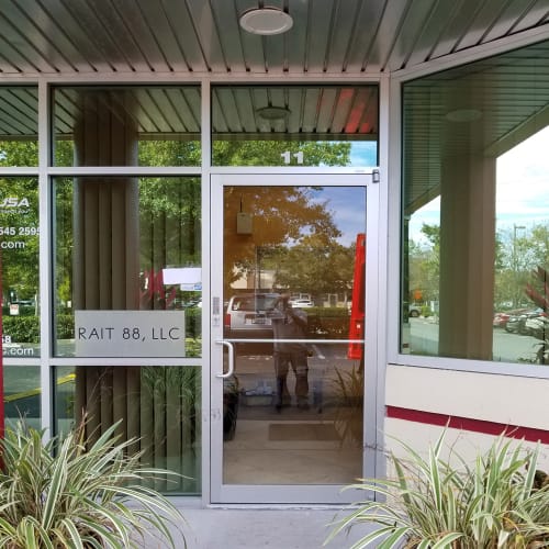 Winter Park office entry door glass replaced after vandalism incident. Click to open in modal.