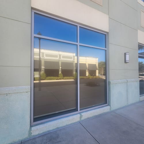 Clermont retail display window boarded up after vandalism damage. Click to open in modal.