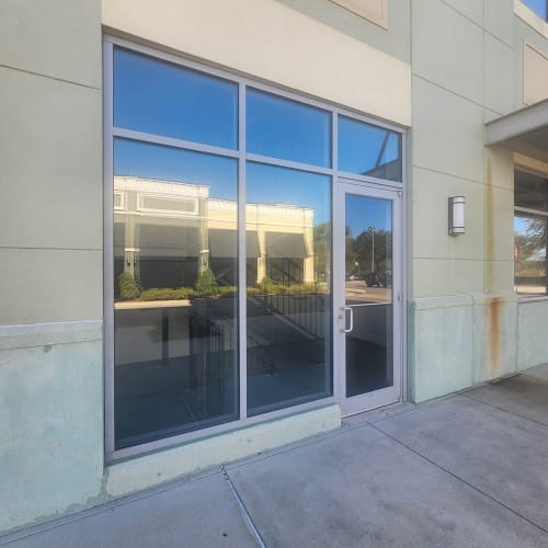 Clermont storefront door and sidelite glass replaced to restore clear entry. Click to open in modal.