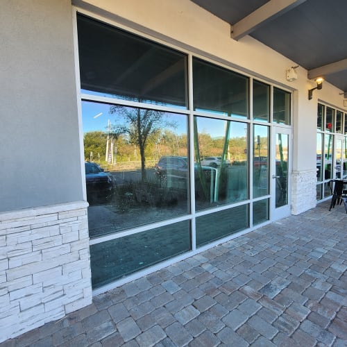 Altamonte Springs office stairwell windows replaced with safety glass panels. Click to open in modal.