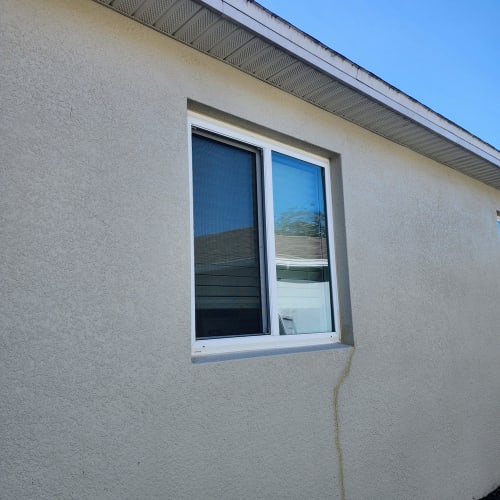 Impact-resistant front window glass installed on an Orlando home facing a busy street. Click to open in modal.