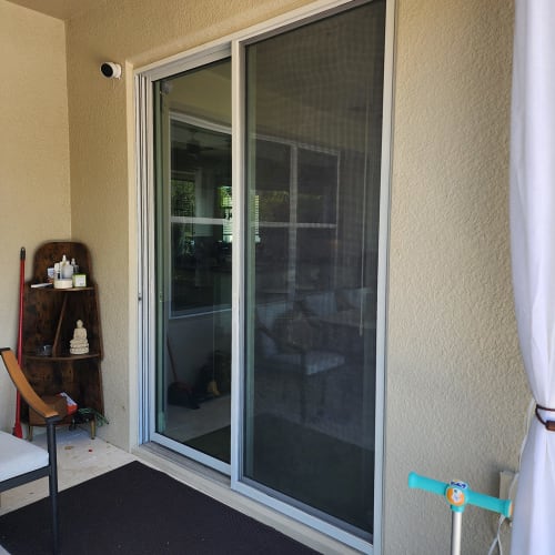 New impact glass sliding door on a Lake Nona patio facing the backyard. Click to open in modal.