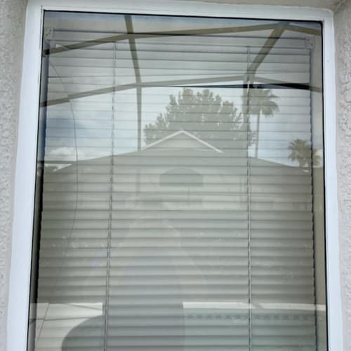 Tempered window glass facing a pool deck at a home near northwest Orlando. Click to open in modal.
