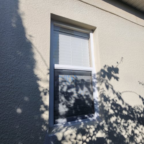 Tempered frosted safety glass installed in a bathroom window in an Orlando home. Click to open in modal.