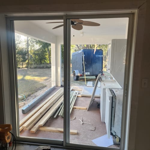 Pool deck sliding glass door in Clermont aligned properly after hardware adjustment. Click to open in modal.
