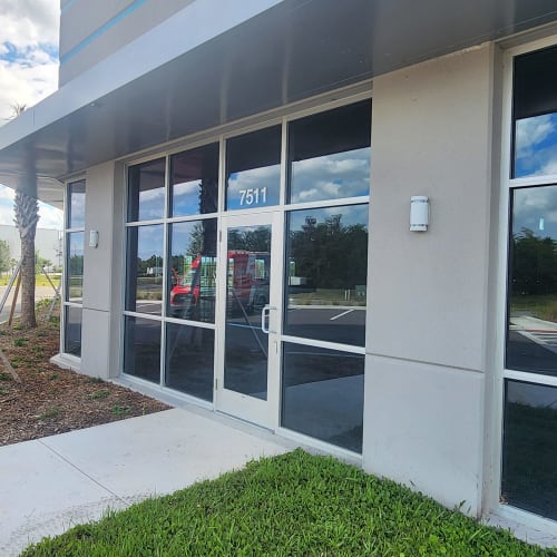 Orlando office lobby transom with clear replacement glass after fogged insulated unit removal. Click to open in modal.