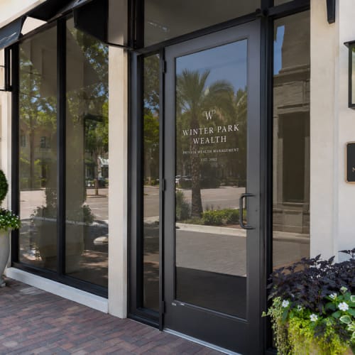 Commercial entry in Winter Park with replaced storefront door glass panel. Click to open in modal.