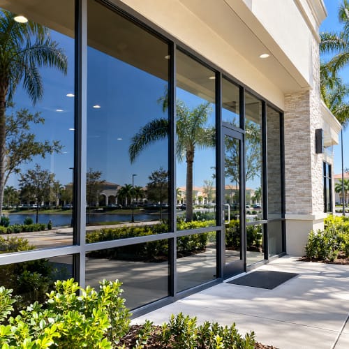 Tinted fixed storefront glass replacement at a Windermere Florida commercial property. Click to open in modal.
