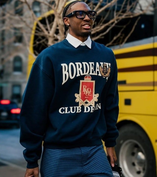 Basketball players wearing streetwear jerseys on an outdoor court
