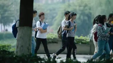 Students walking near a campus street store in Changsha Yuelu district
