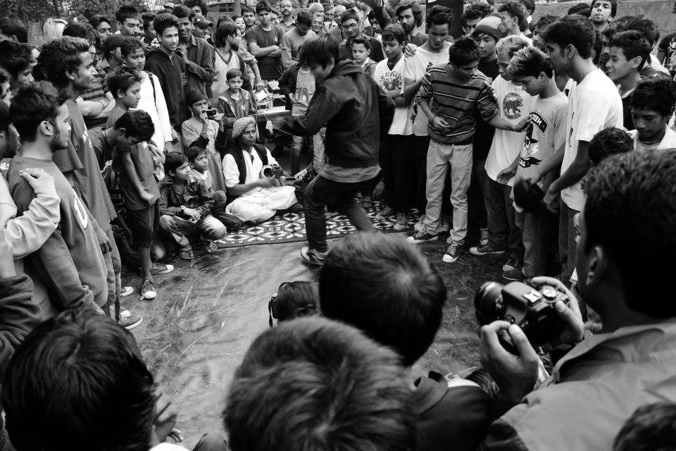 Crowd at a riverside cypher in Changsha at night, high contrast black and white
