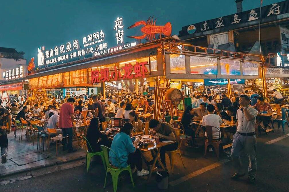 Late night plastic stools and charcoal grill at a Changsha night market
