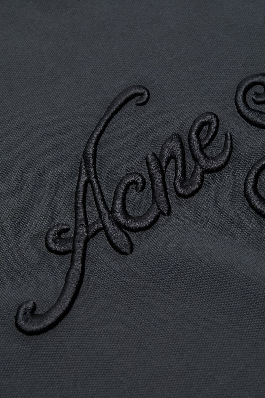 Embroidery detail thumbnail of the tee