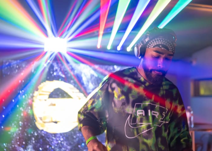 DJ Bandana performs beneath green lasers during a Breakaway after-party at Mutation Brewing.