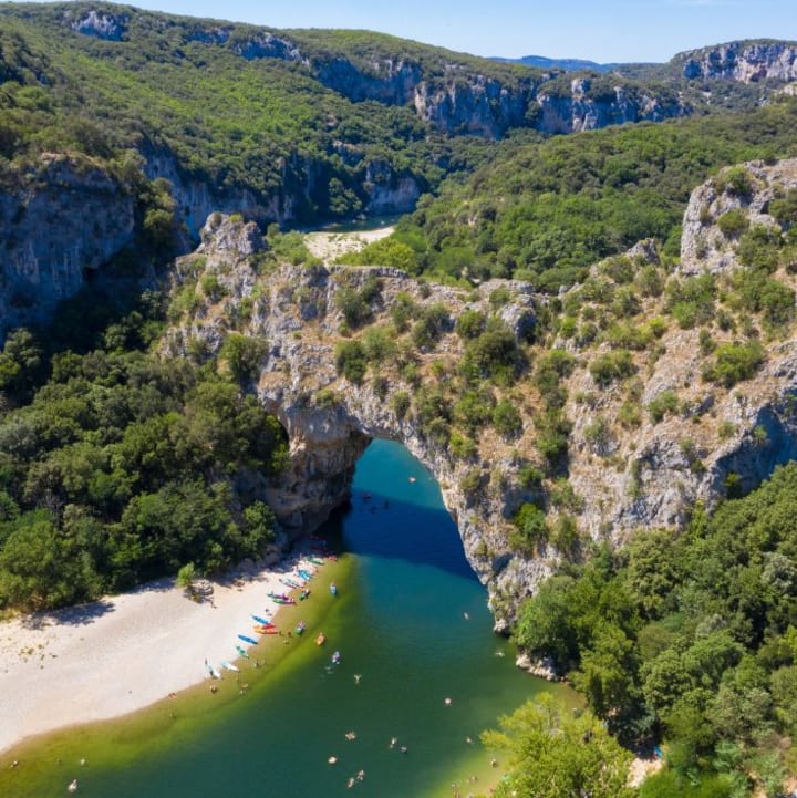 Vue aérienne du Pont d'Arc avec des canoé sur la rive et sur l'eau - Résidence*** Lou castel - Ardèche / Casteljau & Berrias