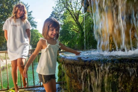 mère et fille au domaine du Château Laval près d'une fontaine