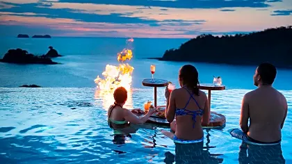 Friends overlooking ocean from pool at Casa Chameleon, Guanacaste