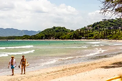 Couple walking down the beach on a sunny day