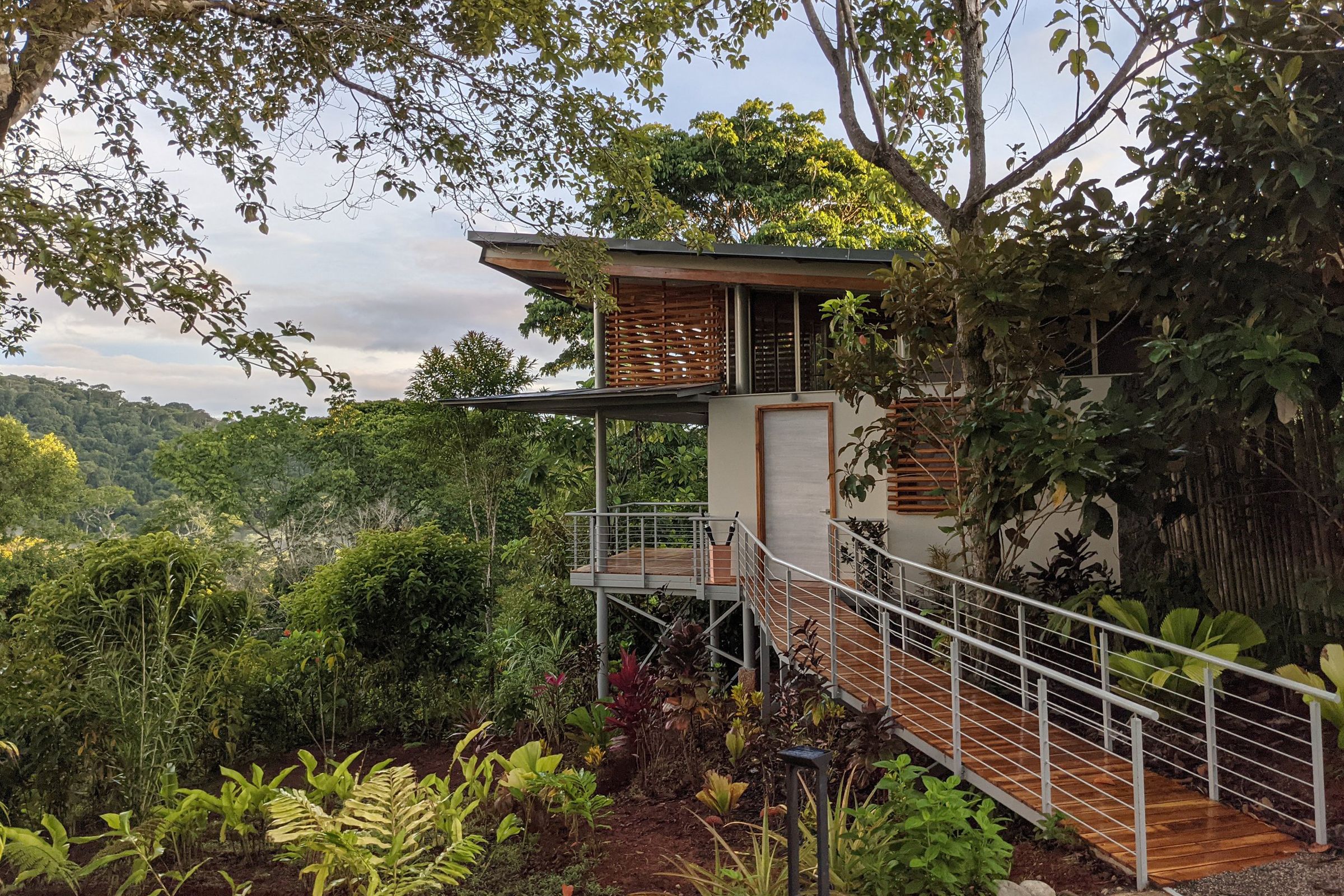 Exterior of Cielo Lodge surrounded by lush gardens and tropical rainforest