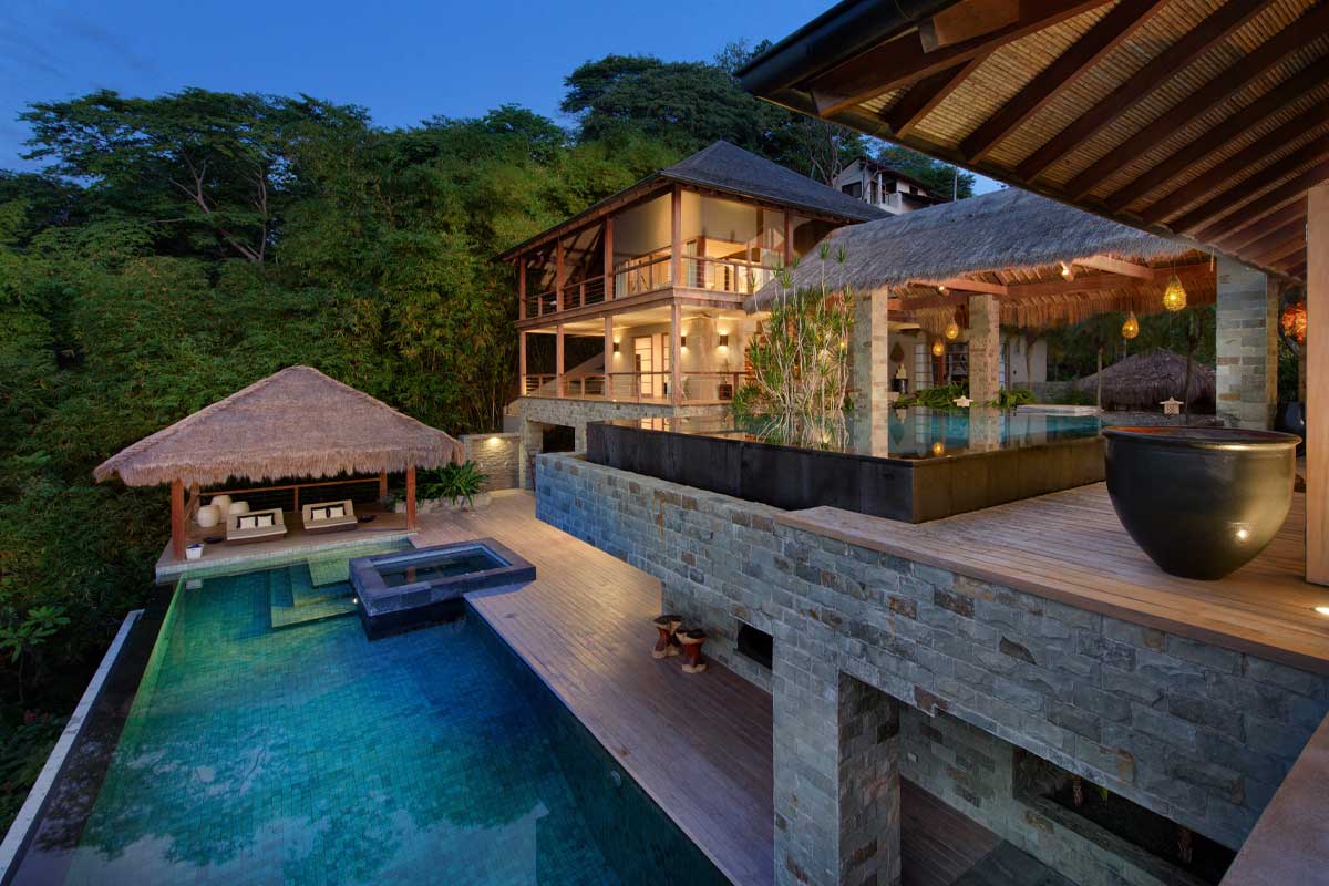 Casa Alang's pool and terrace area, surrounded by rainforest