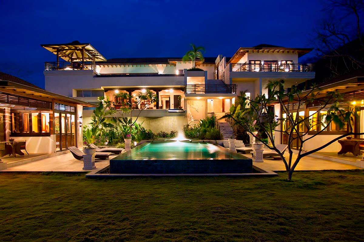 Front garden of Casa Bali, boasting a pool and illuminated terrace