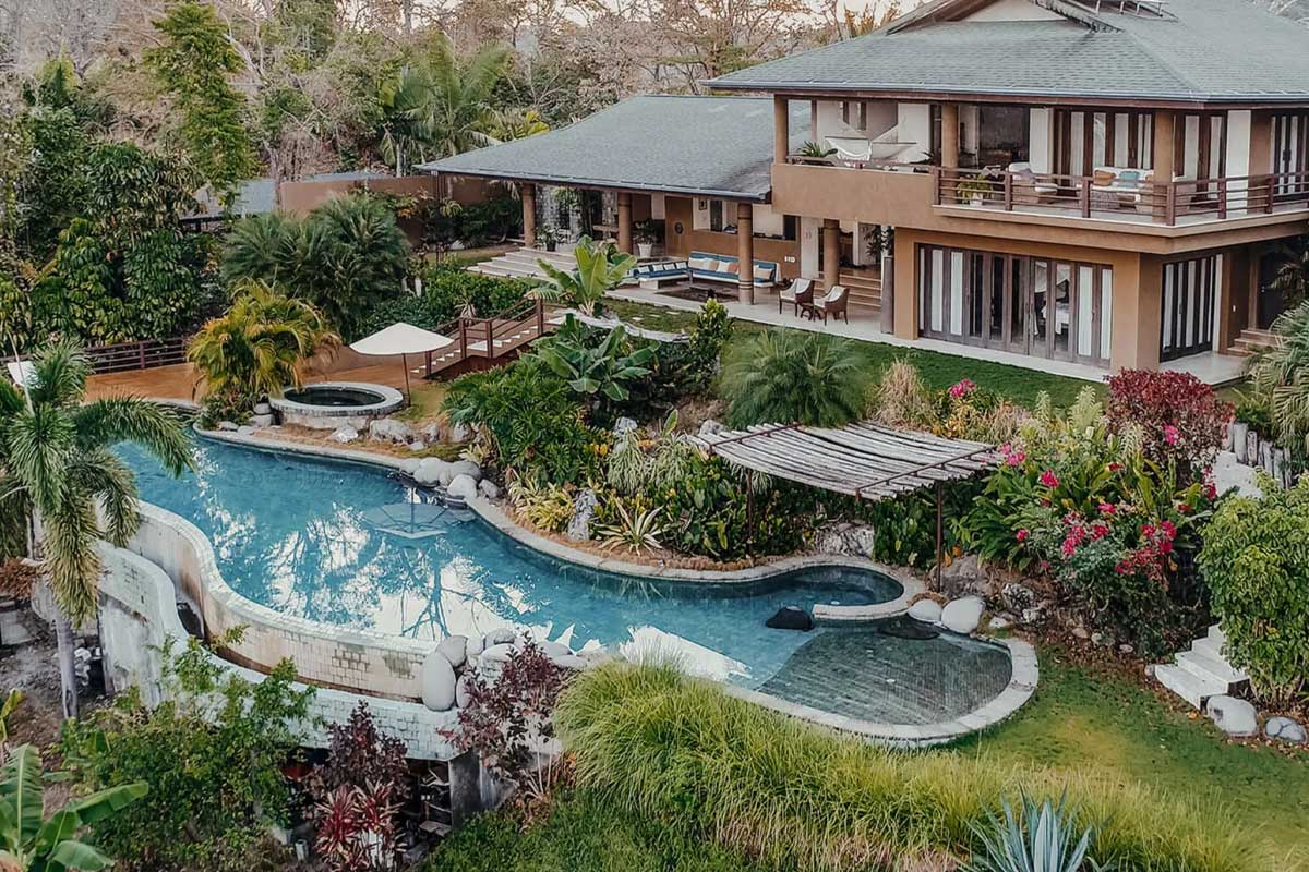 Aerial view of Casa Chameleon's green gardens and fresh pool, in OCIO Villas