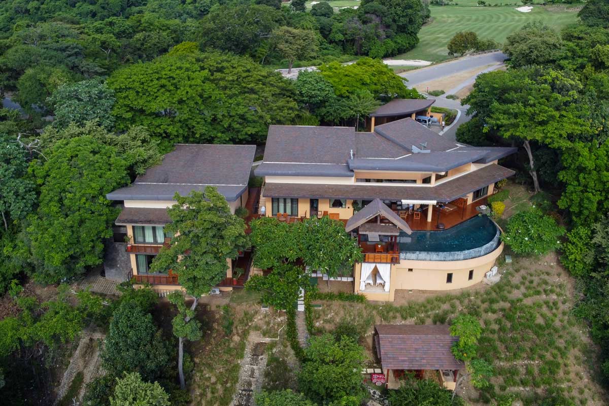 Aerial view of Casa Rosen, perched on a cliff and surrounded by trees