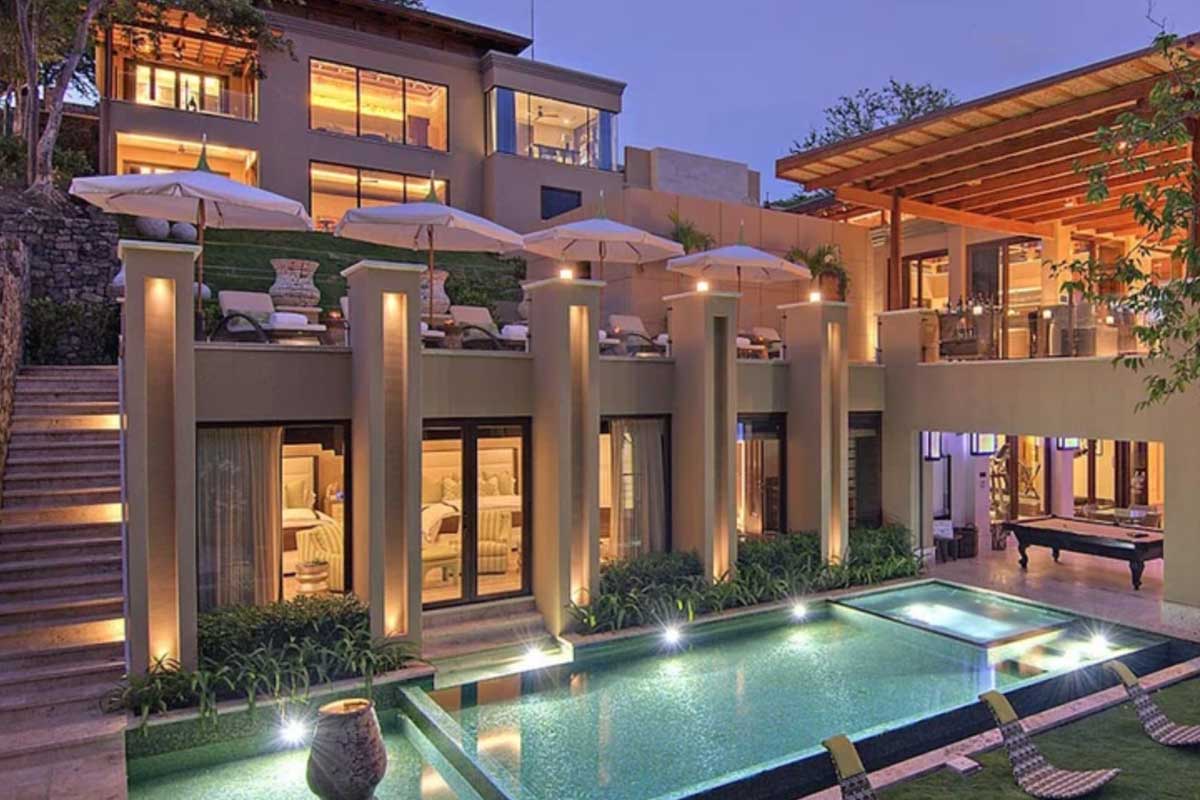 Villa Manzu's deck with sunbeds and lower floor with pool