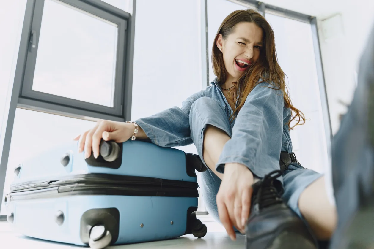 Stress-free travel woman happy with suitcase