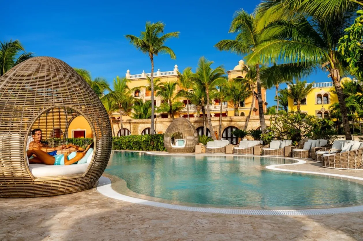 Sanctuary Cap Cana affordable all-inclusive wellness resort couple relaxing by pool