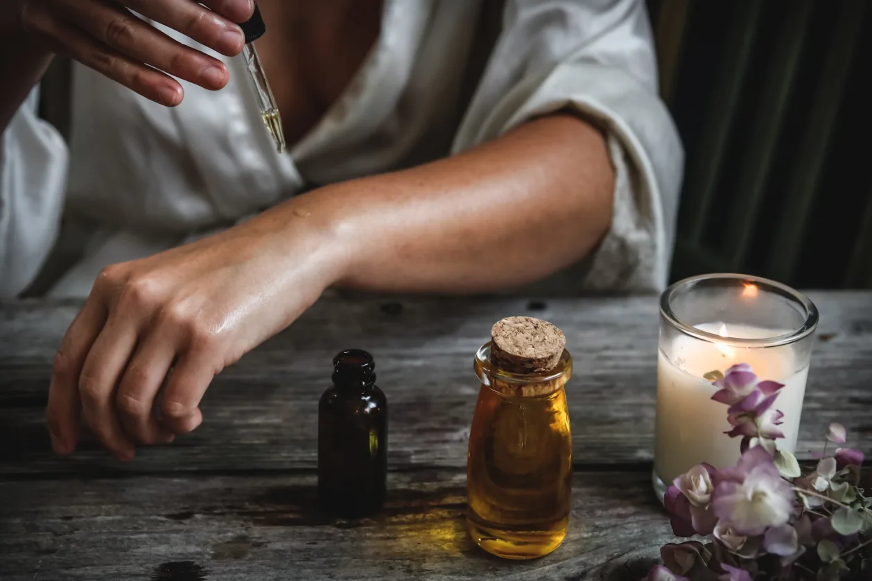 woman applying aromatherapy to arm