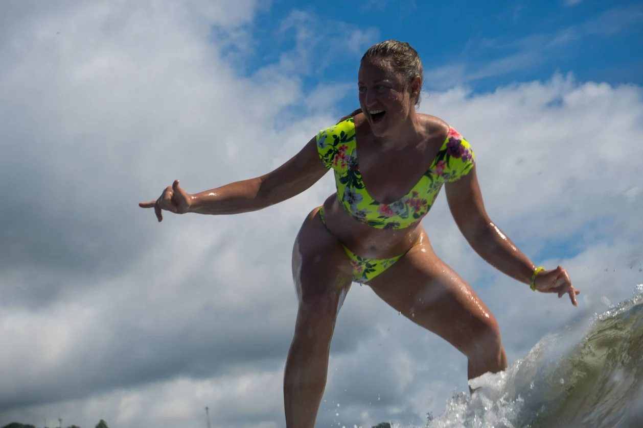 Woman surfing at Bodhi Surf + Yoga