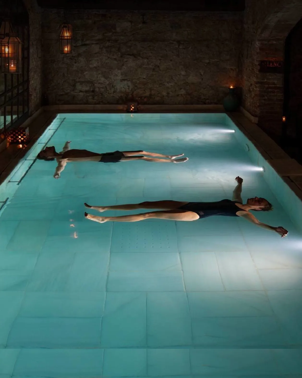 Aire Ancient Baths NYC couple floating in pool