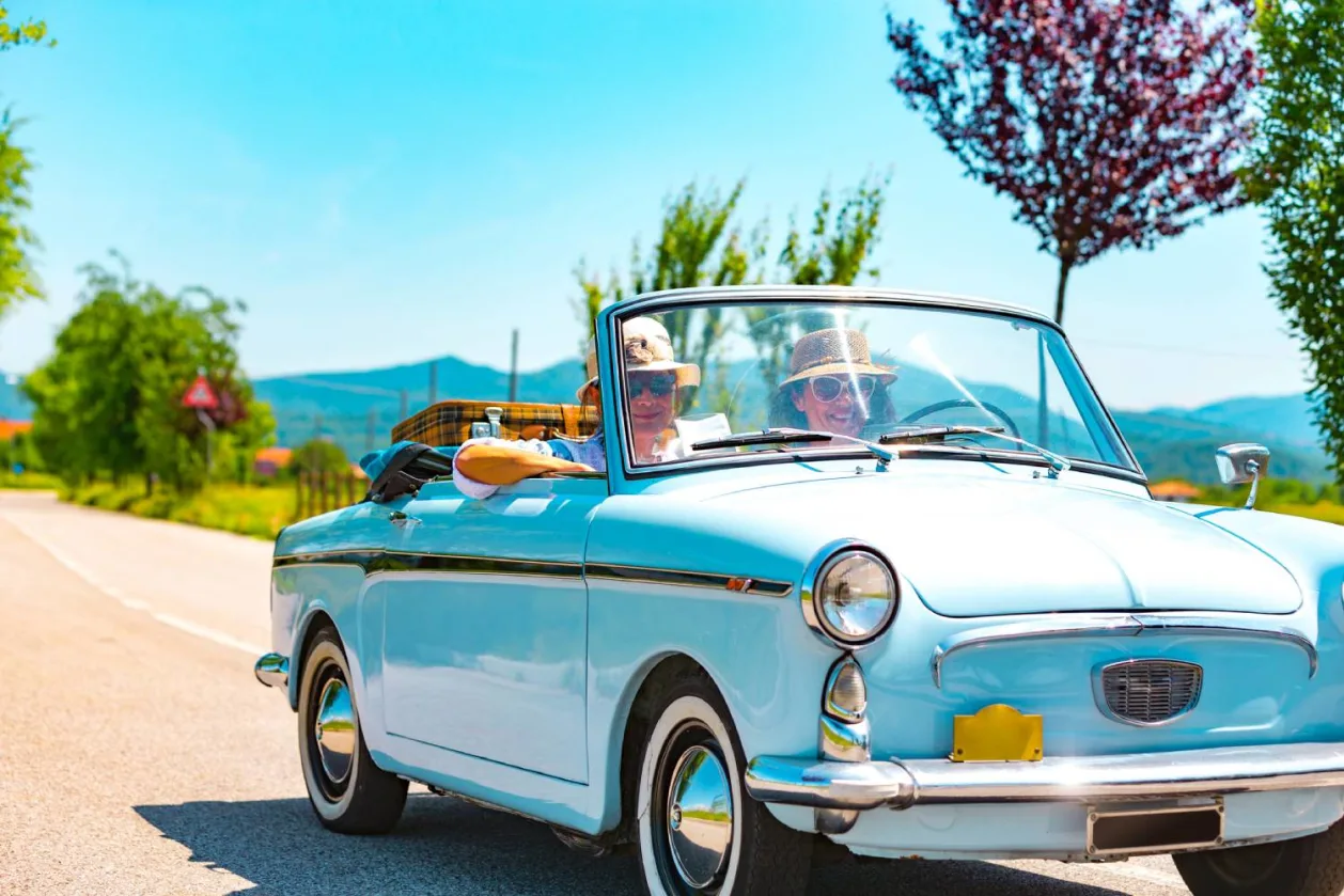 Mature Couple on a Road trip with a Vintage car in Europe