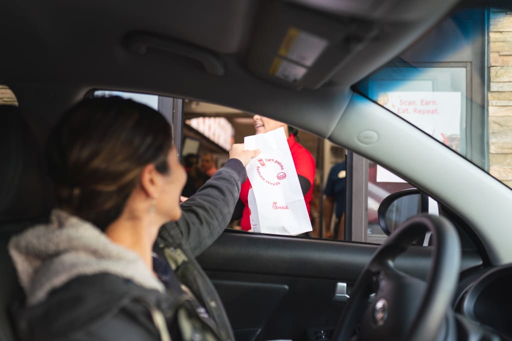 Woman going through drive through