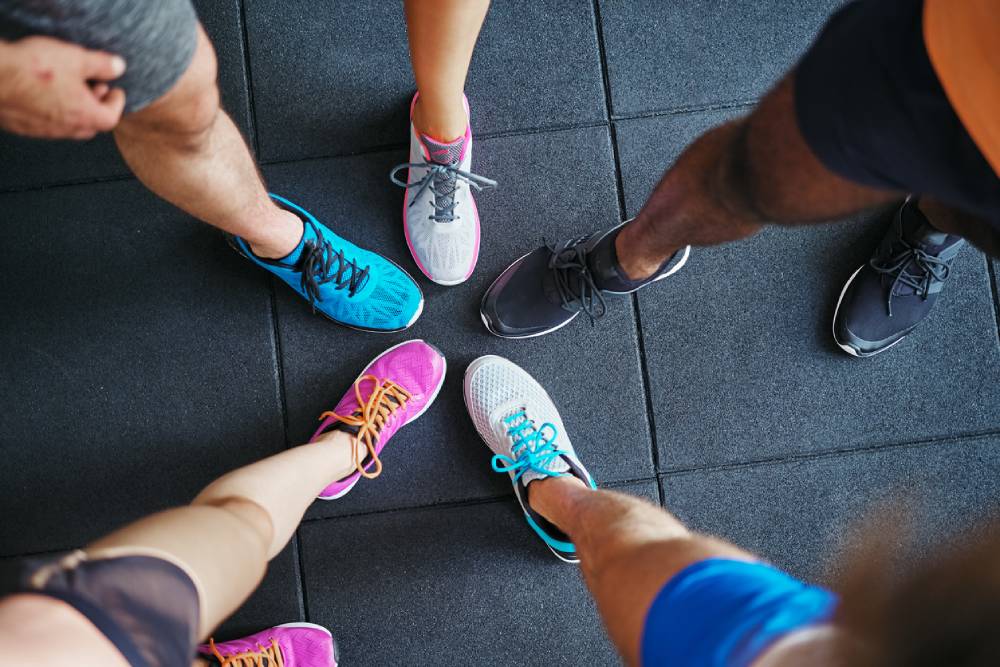 Group of runners showing off running shoes