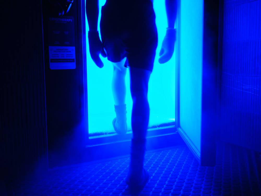 A man entering a cryotherapy cold therapy chamber