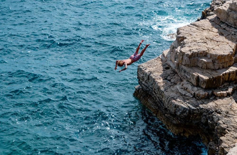 Man cliff diving in Pula Croatia
