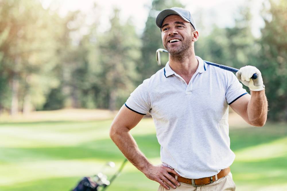 Smiling golf player on the course