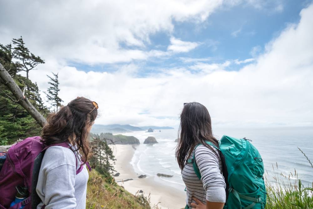 Sisters hiking cliff above Cannon Beach Oregon