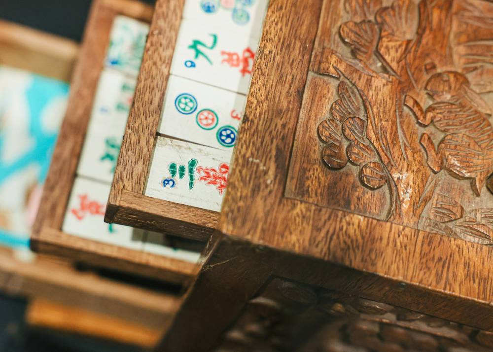 Mahjong tiles in intricately carved wooden box