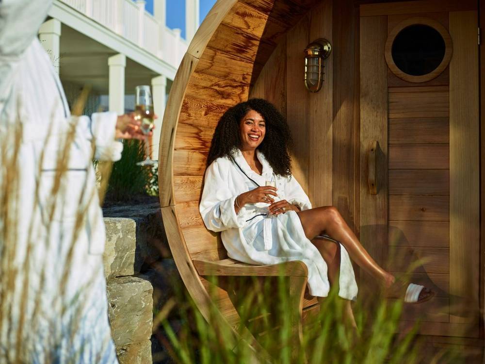 Guest in spa bathrobe in barrel sauna at The Lake House On Canandaigua